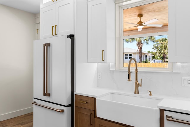 6424 Sunset Ave, Panama City Beach, FL 32408 - kitchen featuring freestanding refrigerator, a sink, white cabinets, and a ceiling fan