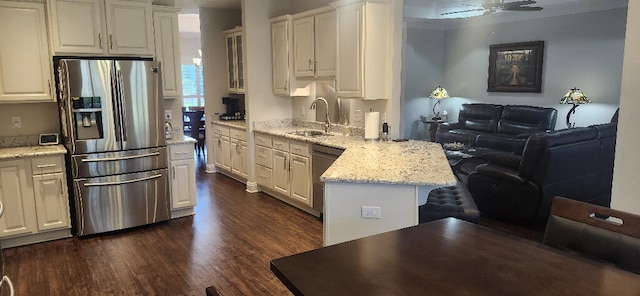 3100 Oriole Dr, Gulf Breeze, FL 32563 - kitchen with appliances with stainless steel finishes, a sink, a peninsula, dark wood-type flooring, and open floor plan