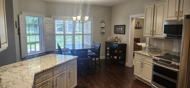 3100 Oriole Dr, Gulf Breeze, FL 32563 - kitchen with stainless steel appliances, plenty of natural light, dark wood-style floors, and a chandelier