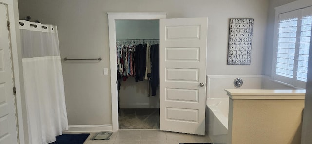 3100 Oriole Dr, Gulf Breeze, FL 32563 - bathroom featuring tile patterned flooring, plenty of natural light, a bath, and a shower with shower curtain
