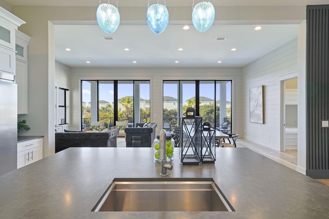 336 S Holiday Rd, Destin, FL 32550 - kitchen featuring dark countertops, open floor plan, recessed lighting, pendant lighting, and white cabinets