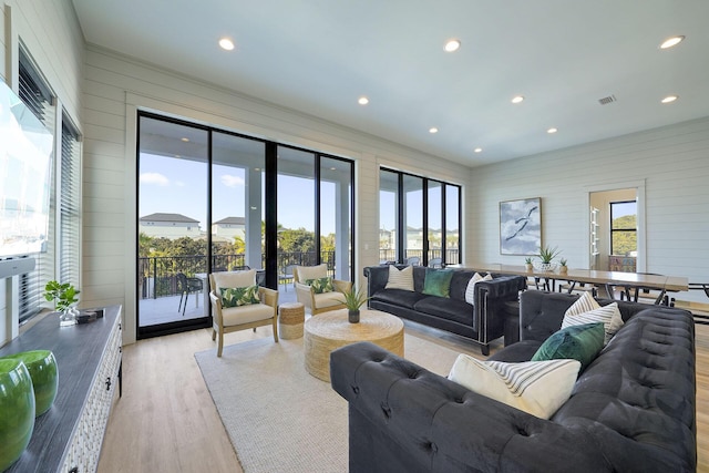 336 S Holiday Rd, Destin, FL 32550 - living area with light wood-type flooring, wood walls, and recessed lighting