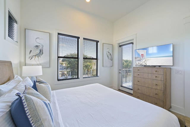 336 S Holiday Rd, Destin, FL 32550 - bedroom featuring baseboards, wood finished floors, and access to exterior