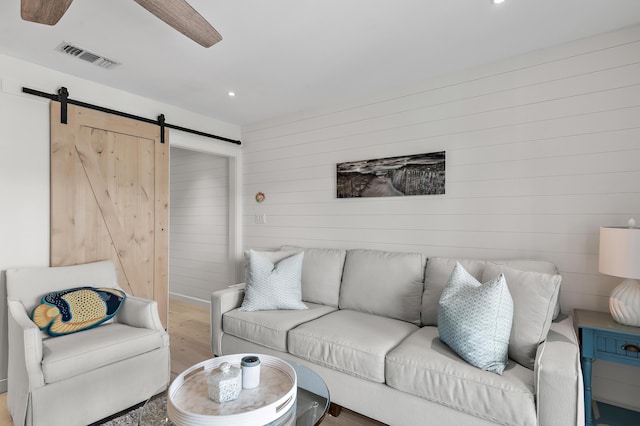 2384 Scenic Gulf Dr Unit C308, Miramar Beach, FL 32550 - living room with a barn door, wood finished floors, ceiling fan, wood walls, and recessed lighting
