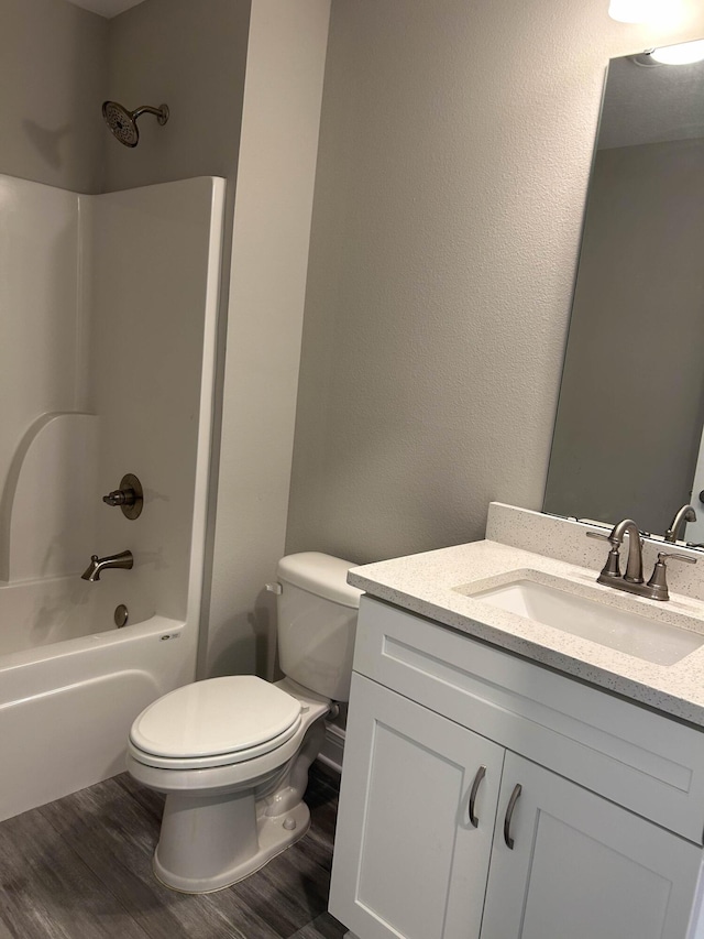 3154 Maple St, Crestview, FL 32539 - full bathroom with vanity, toilet, tub / shower combination, and wood finished floors