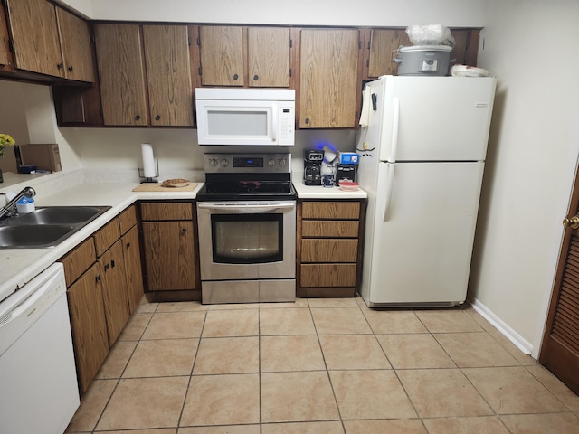 696 Tyner St Unit 7, Fort Walton Beach, FL 32547 - kitchen with white appliances, light countertops, and light tile patterned floors