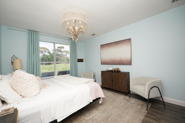 2905 Shalimar Ln, Shalimar, FL 32579 - bedroom featuring wood finished floors, a chandelier, access to exterior, and baseboards