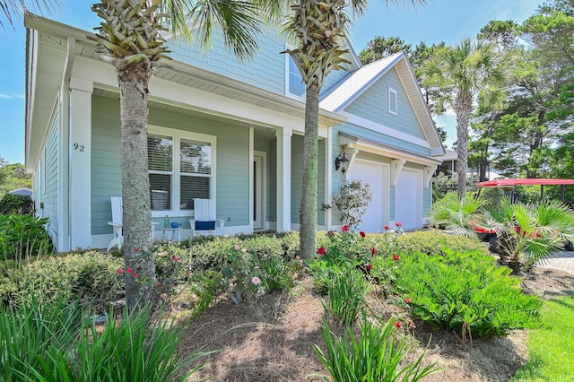 92 Maple St, Santa Rosa Beach, FL 32459 - view of front facade featuring a porch and a garage