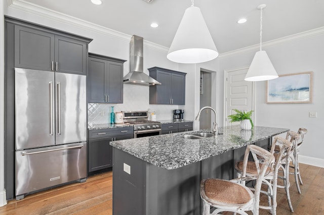 92 Maple St, Santa Rosa Beach, FL 32459 - kitchen featuring appliances with stainless steel finishes, wall chimney exhaust hood, light wood-style flooring, stone counters, and ornamental molding