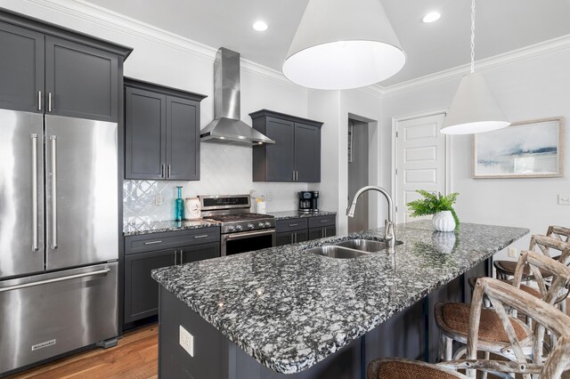 92 Maple St, Santa Rosa Beach, FL 32459 - kitchen featuring appliances with stainless steel finishes, wall chimney range hood, crown molding, a breakfast bar, and dark stone countertops