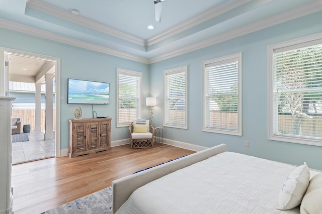 92 Maple St, Santa Rosa Beach, FL 32459 - bedroom with wood finished floors, a tray ceiling, ornamental molding, and ceiling fan