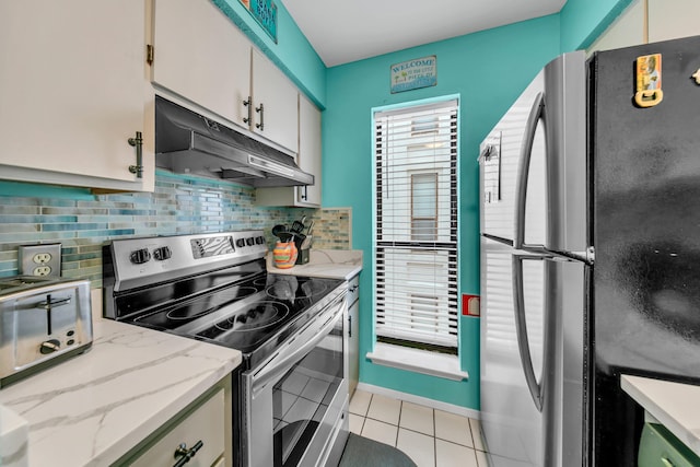 17614 Front Beach Rd Unit D13, Panama City Beach, FL 32413 - kitchen featuring under cabinet range hood, appliances with stainless steel finishes, tasteful backsplash, and light tile patterned floors