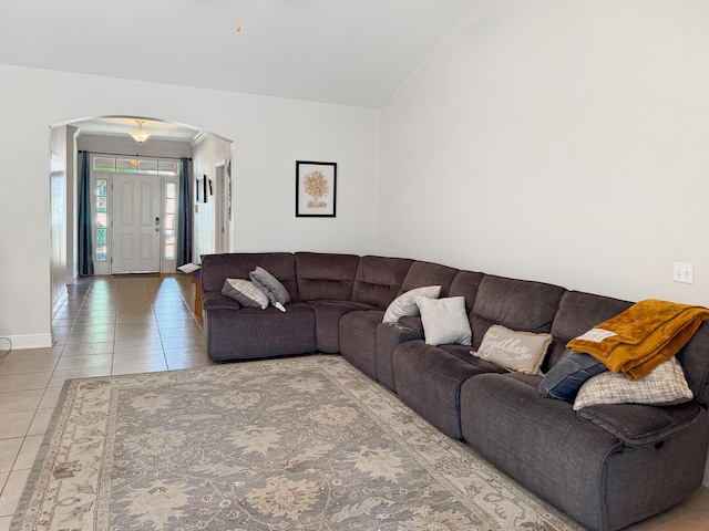 312 Scotch Pine Ln, Crestview, FL 32536 - tiled living room featuring arched walkways, lofted ceiling, and baseboards