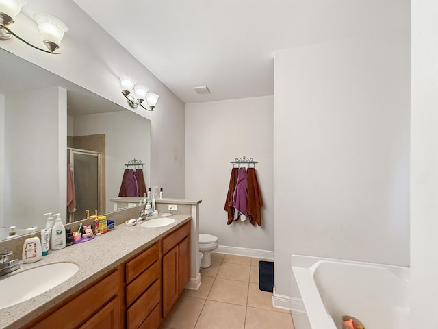 312 Scotch Pine Ln, Crestview, FL 32536 - bathroom featuring tile patterned floors, a shower stall, double vanity, toilet, and a bath