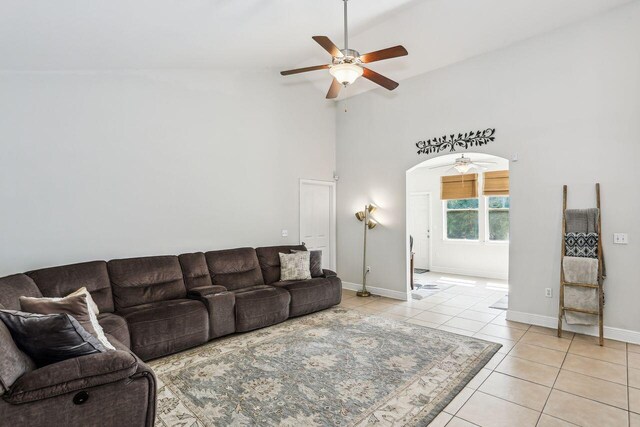 312 Scotch Pine Ln, Crestview, FL 32536 - living room with ceiling fan, light tile patterned floors, high vaulted ceiling, baseboards, and arched walkways
