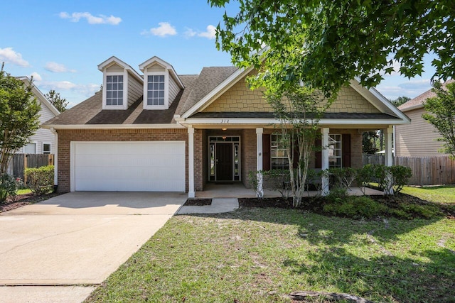 312 Scotch Pine Ln, Crestview, FL 32536 - view of front of home with a garage, brick siding, a porch, driveway, and a shingled roof