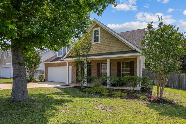 312 Scotch Pine Ln, Crestview, FL 32536 - view of front facade with covered porch, driveway, brick siding, an attached garage, and roof with shingles