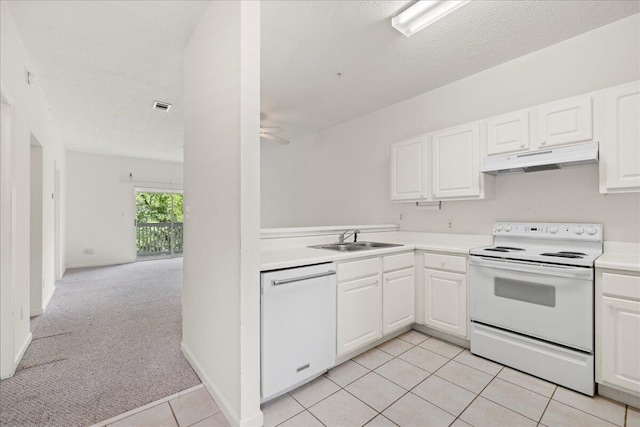 34 Herons Watch Way Unit 1203, Santa Rosa Beach, FL 32459 - kitchen with white appliances, a sink, under cabinet range hood, light tile patterned flooring, and white cabinets