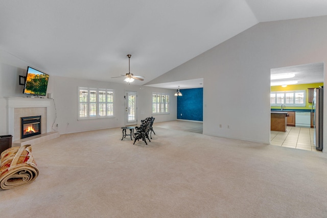 207 E Shipwreck Rd, Santa Rosa Beach, FL 32459 - living room with a tile fireplace, light colored carpet, healthy amount of natural light, a ceiling fan, and high vaulted ceiling