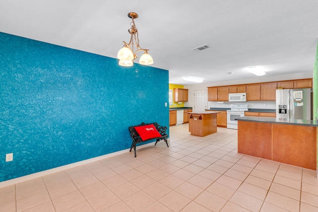 207 E Shipwreck Rd, Santa Rosa Beach, FL 32459 - kitchen featuring white appliances, a kitchen island, decorative light fixtures, baseboards, and brown cabinetry