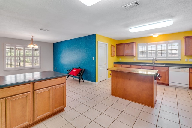 207 E Shipwreck Rd, Santa Rosa Beach, FL 32459 - kitchen featuring dishwasher, a sink, a center island, dark countertops, and a textured ceiling