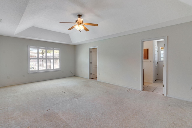 207 E Shipwreck Rd, Santa Rosa Beach, FL 32459 - unfurnished bedroom featuring a tray ceiling, multiple windows, carpet floors, and baseboards