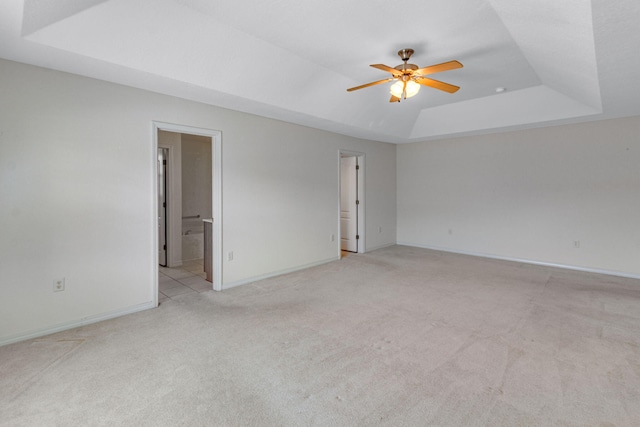 207 E Shipwreck Rd, Santa Rosa Beach, FL 32459 - spare room with a raised ceiling, light carpet, a ceiling fan, and baseboards