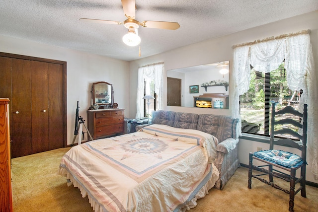 2509 S Lakeview Dr, Crestview, FL 32536 - bedroom with light colored carpet, a closet, a textured ceiling, and ceiling fan