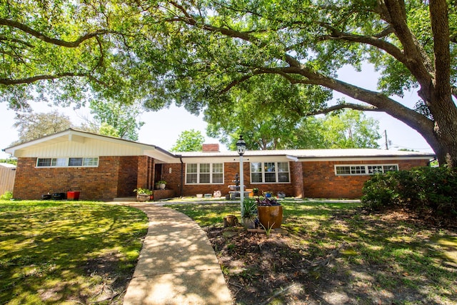 210 NW Pleasant St, Fort Walton Beach, FL 32548 - ranch-style home with brick siding and a chimney