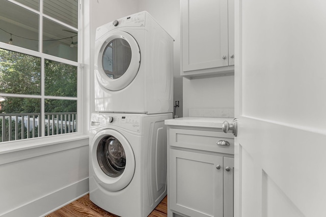 515 Seacrest Dr, Inlet Beach, FL 32461 - washroom with stacked washing machine and dryer, cabinet space, and wood finished floors