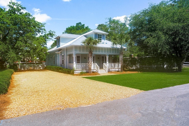 515 Seacrest Dr, Inlet Beach, FL 32461 - country-style home featuring a porch, a front yard, metal roof, and driveway