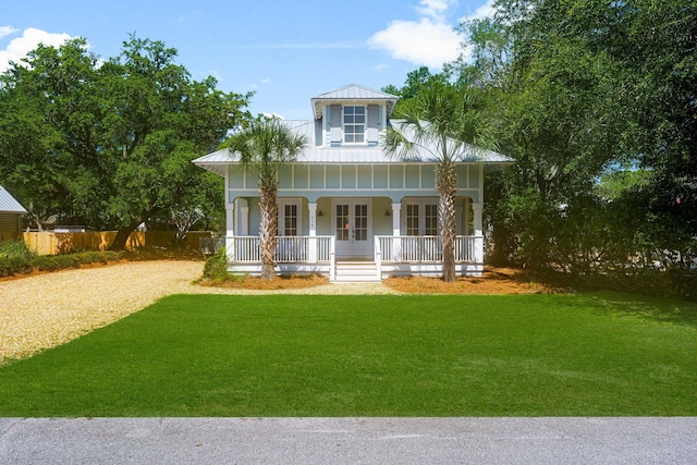 515 Seacrest Dr, Inlet Beach, FL 32461 - view of front of home featuring a porch, french doors, gravel driveway, and metal roof