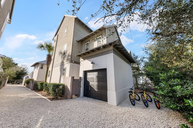 106 N Winston Ln, Inlet Beach, FL 32461 - view of home's exterior featuring driveway, stucco siding, and an attached garage