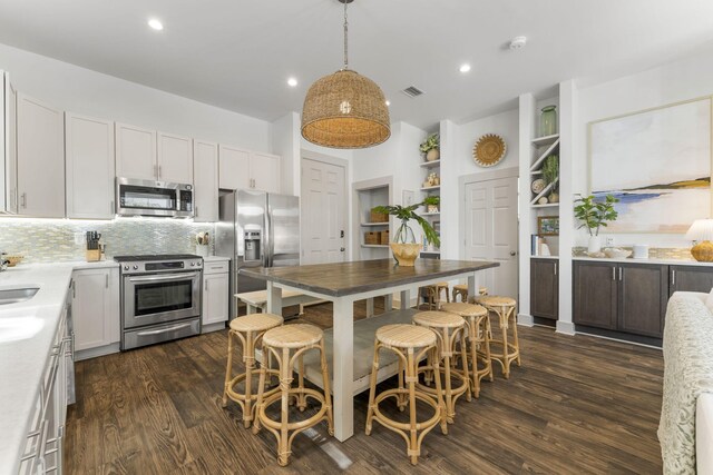 106 N Winston Ln, Inlet Beach, FL 32461 - kitchen with stainless steel appliances, dark wood finished floors, backsplash, light countertops, and recessed lighting