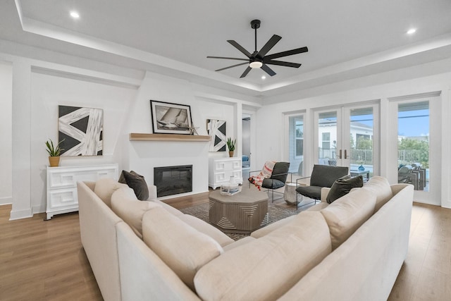 425 W Lafayette, Inlet Beach, FL 32461 - living area featuring a tray ceiling, french doors, a glass covered fireplace, wood finished floors, and recessed lighting