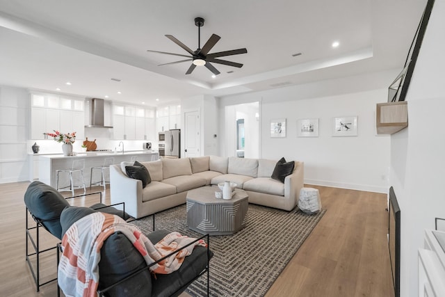 425 W Lafayette, Inlet Beach, FL 32461 - living room with a ceiling fan, light wood-style flooring, a raised ceiling, recessed lighting, and baseboards