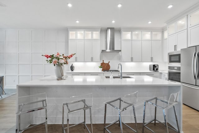 425 W Lafayette, Inlet Beach, FL 32461 - kitchen with wall chimney range hood, stainless steel appliances, a sink, light countertops, and a large island