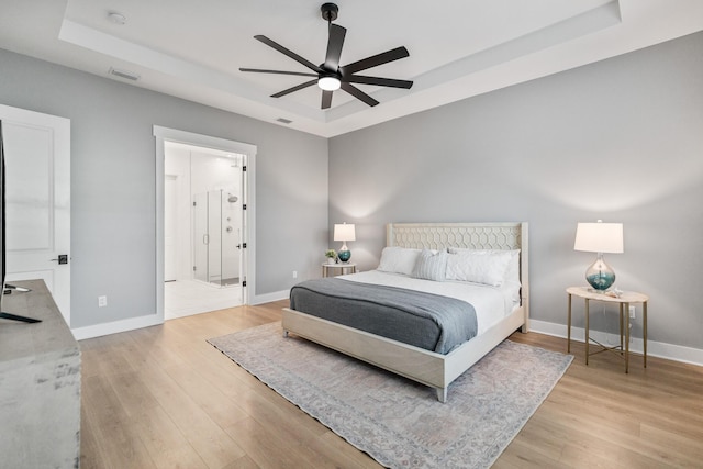 425 W Lafayette, Inlet Beach, FL 32461 - bedroom featuring a tray ceiling, light wood finished floors, and baseboards
