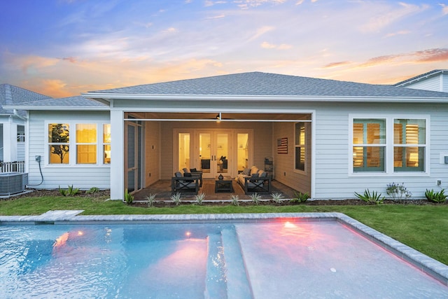 425 W Lafayette, Inlet Beach, FL 32461 - back of property at dusk with a patio, an outdoor pool, central AC unit, uncovered parking, and a shingled roof