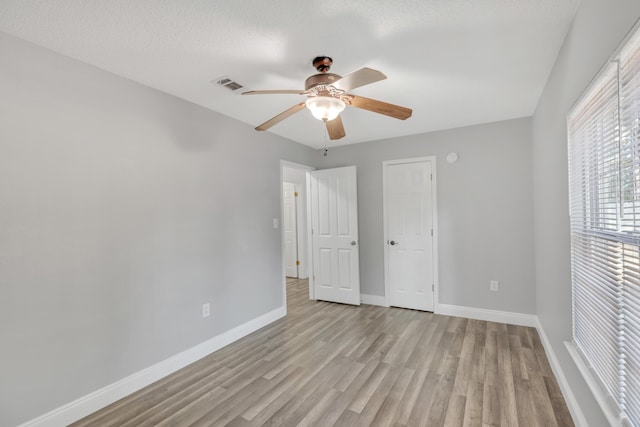 319 Jones Rd, Crestview, FL 32536 - unfurnished bedroom with baseboards, light wood finished floors, and ceiling fan