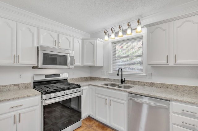 319 Jones Rd, Crestview, FL 32536 - kitchen featuring stainless steel appliances, a sink, white cabinets, a textured ceiling, and light stone countertops
