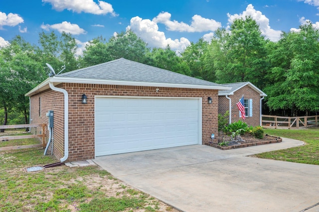 41 S Hidden Lakes Trl, Defuniak Springs, FL 32433 - view of front of home with fence, brick siding, concrete driveway, an attached garage, and roof with shingles