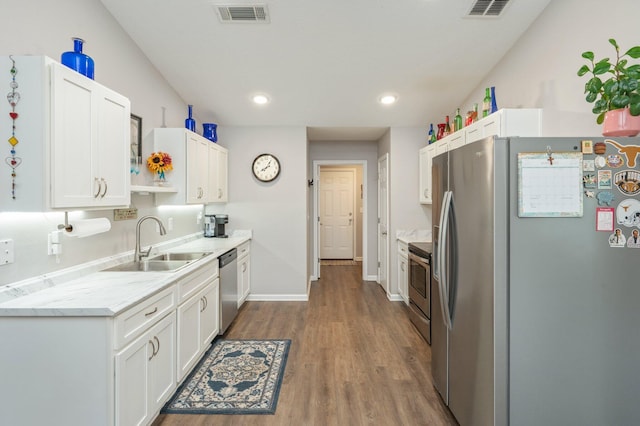 41 S Hidden Lakes Trl, Defuniak Springs, FL 32433 - kitchen featuring appliances with stainless steel finishes, a sink, white cabinetry, wood finished floors, and baseboards