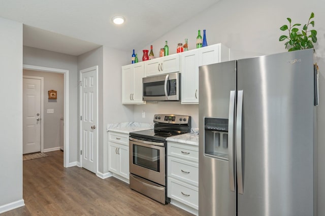 41 S Hidden Lakes Trl, Defuniak Springs, FL 32433 - kitchen with appliances with stainless steel finishes, white cabinetry, wood finished floors, baseboards, and recessed lighting