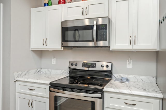 41 S Hidden Lakes Trl, Defuniak Springs, FL 32433 - kitchen with appliances with stainless steel finishes, white cabinets, and light stone counters
