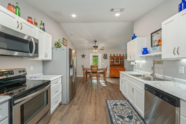 41 S Hidden Lakes Trl, Defuniak Springs, FL 32433 - kitchen featuring stainless steel appliances, a sink, open shelves, ceiling fan, and light wood-type flooring