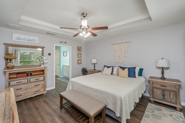 41 S Hidden Lakes Trl, Defuniak Springs, FL 32433 - bedroom with a tray ceiling, dark wood-type flooring, ornamental molding, baseboards, and ensuite bath