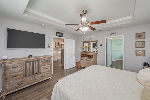 41 S Hidden Lakes Trl, Defuniak Springs, FL 32433 - bedroom with a tray ceiling, ornamental molding, dark wood-style floors, ensuite bathroom, and a sink