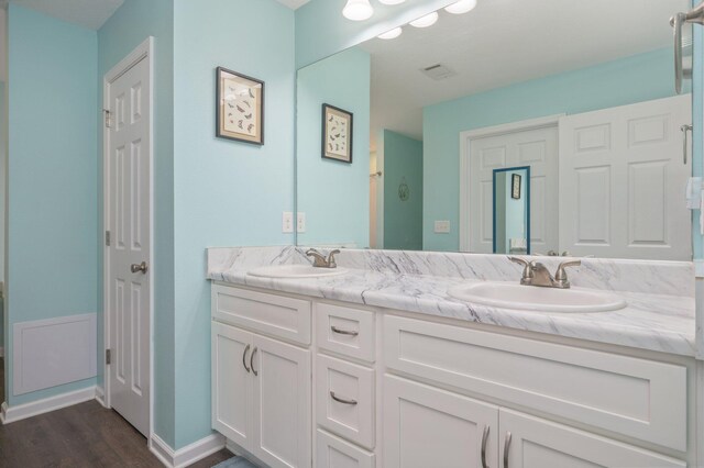 41 S Hidden Lakes Trl, Defuniak Springs, FL 32433 - bathroom featuring wood finished floors, double vanity, and baseboards