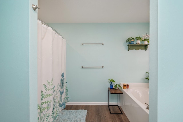 41 S Hidden Lakes Trl, Defuniak Springs, FL 32433 - bathroom with wood finished floors and a garden tub